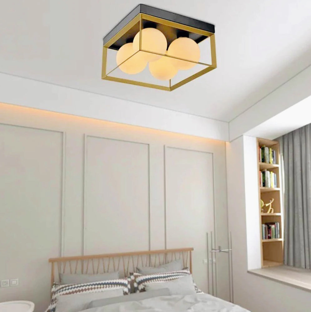 Plafoniera minimalista in metallo nero e bronzo con 4 sfere opache - attacco G9 - ambraled